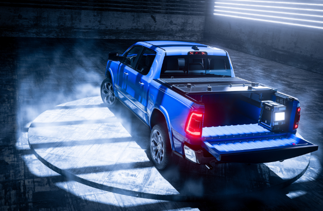 Blue pickup truck with tailgate down in a dimly lit, smoky garage