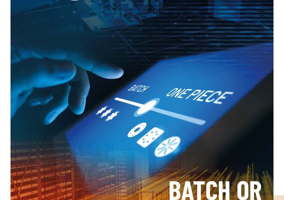 Magazine cover with a touchscreen labeled batch and one-piece flow, manufacturing theme.