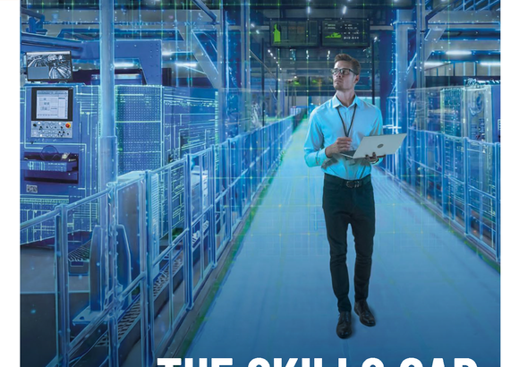 Magazine cover showing a man with a laptop in an automated factory setting.