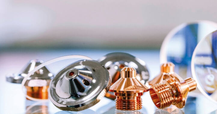Close-up of metal and copper machine parts on a reflective surface.